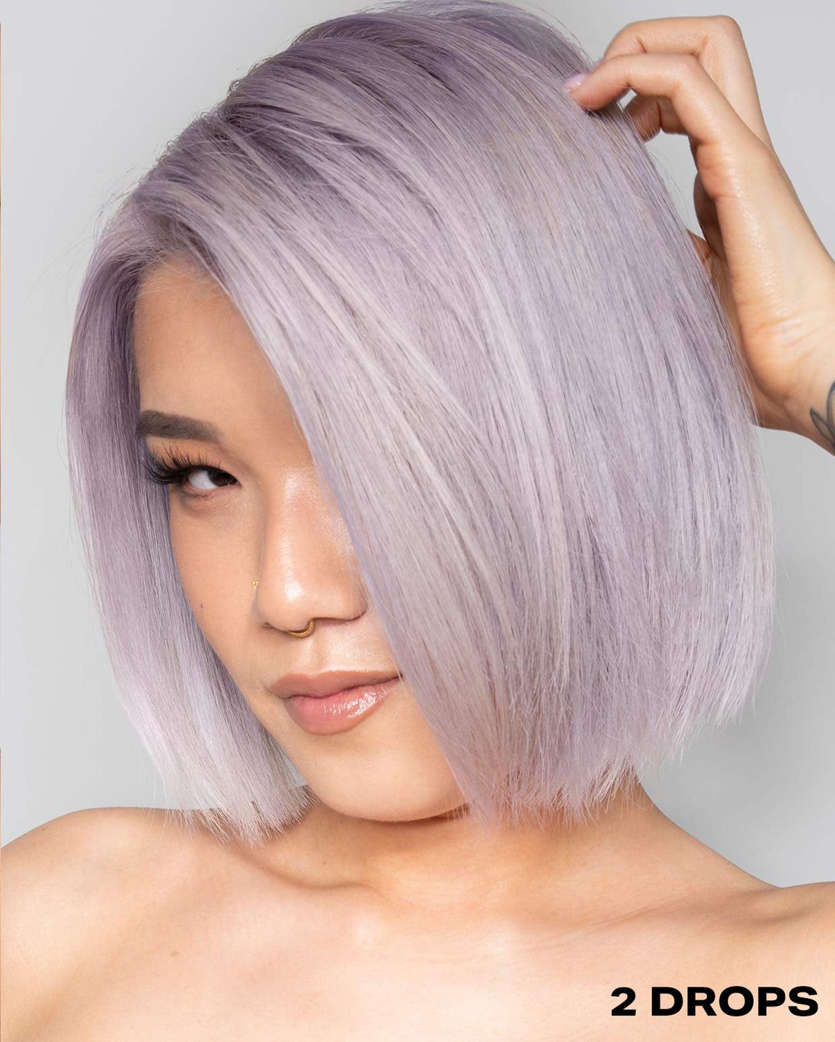 Model with two drops of the Shrine Drop it  Lilac Toner 