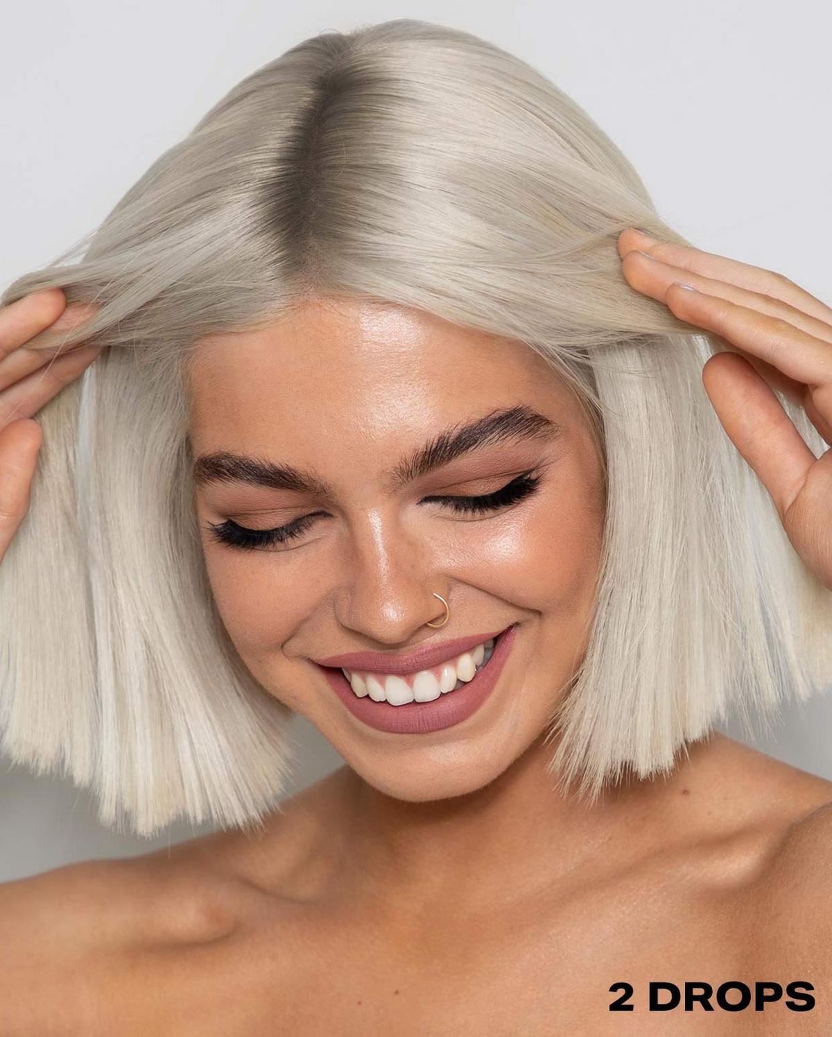Short haired model showing two drop of the Shrine Drop It Blonde for days 